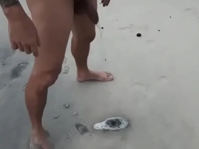 Mature man dedicating his golden shower on the nude beach