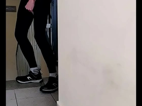 Young guy in lycra leggings jerks off in a corridor